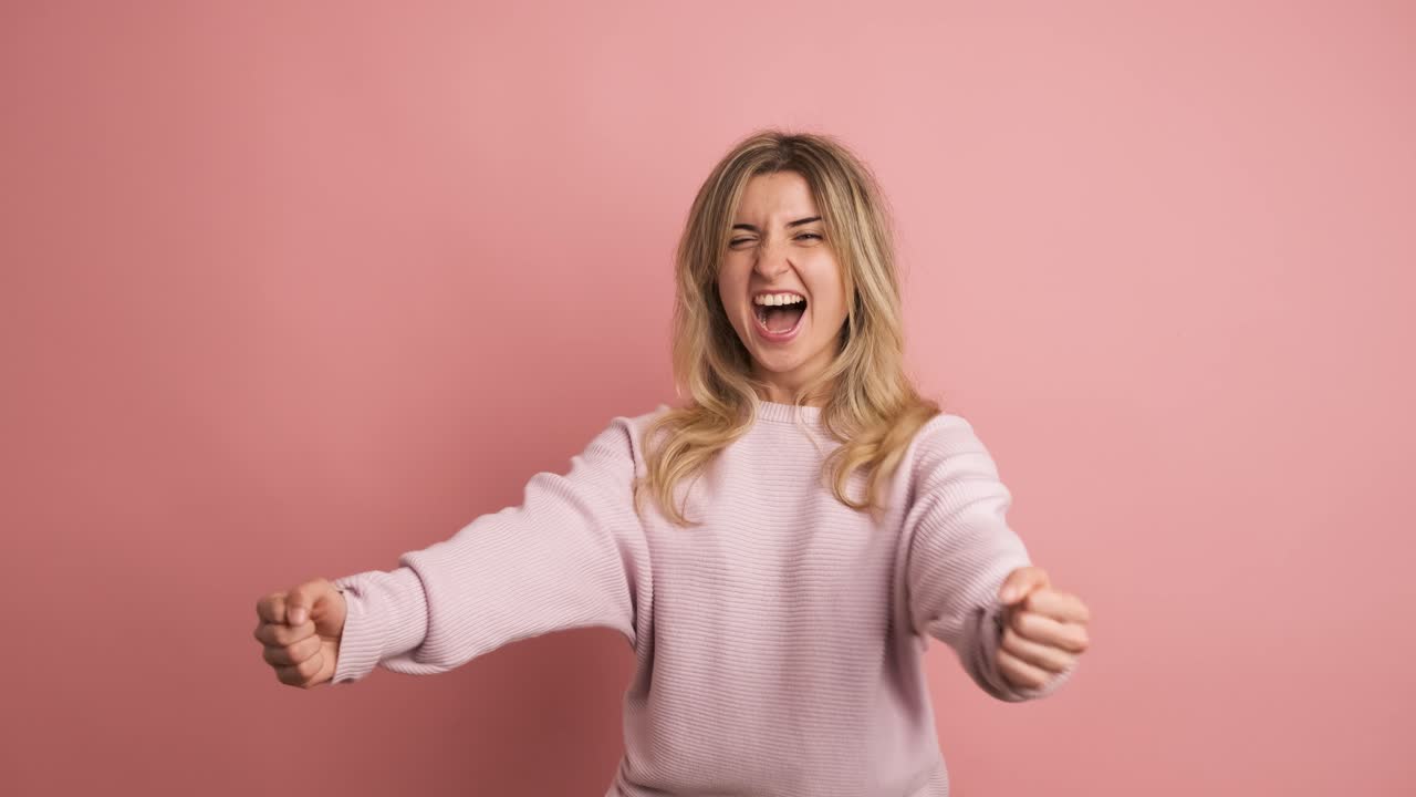 Woman celebrating energetically raising fists