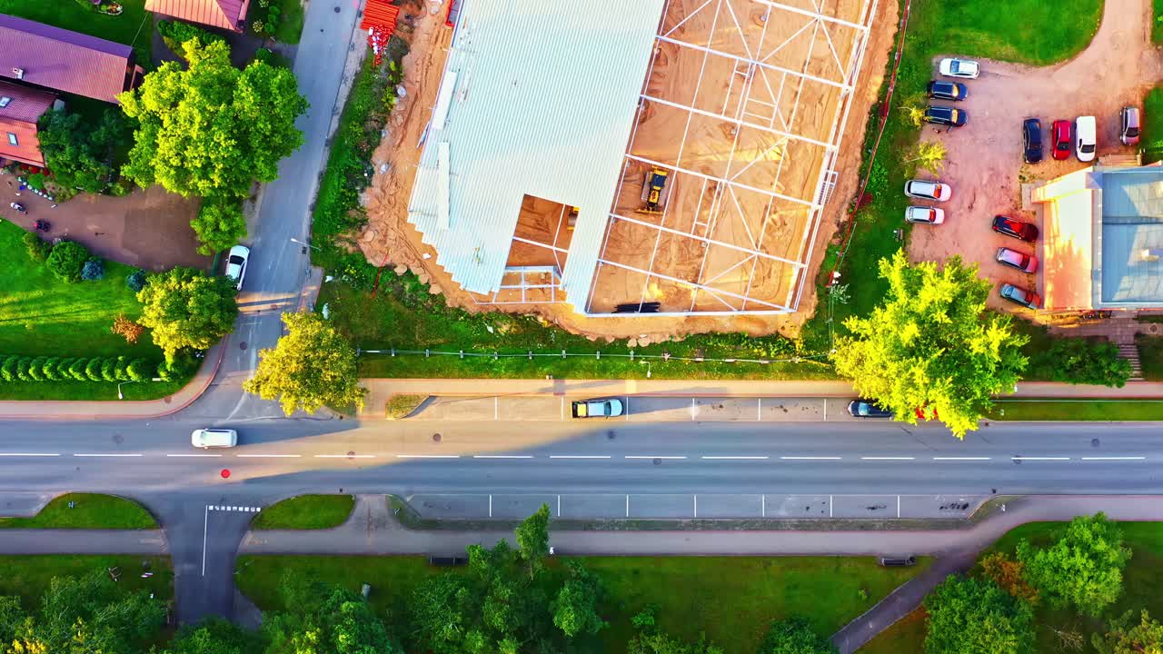 Top-down view of metal frame construction for warehouse in residential area in Smiltene