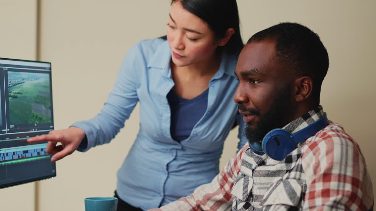 Diverse team of videographers working on movie footage edit