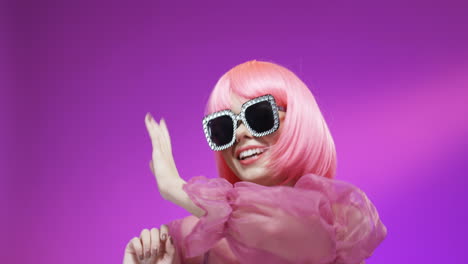 portrait of beautiful woman wearing a pink wig and fancy glasses