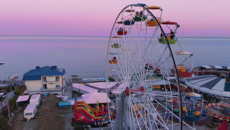 ferris wheel on the background of the sea at sunset. view from above