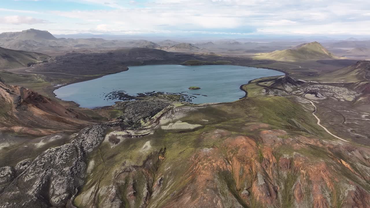 Aerial approaching shot of Frostastadavatn Lake in highlands of Iceland. Sunny day in fall season. Beautiful scenery view of Icelandic mountains