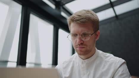 adult man is consulting clients by online chat on site of company, technical service and support, portrait