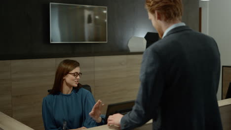 african woman working at corporate office reception, office secretary