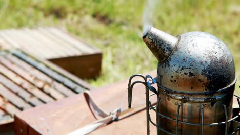 Bee-smoker-on-wooden-plank