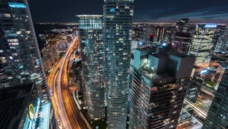 the gardiner expressway from day to night as seen from the top of a skyscraper