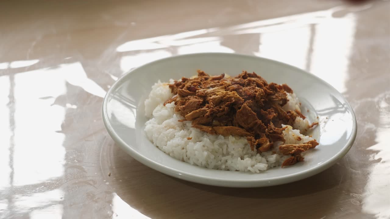 Close-Up Static Shot of Chicken Pastil Served Over Steamed Rice Being Eaten