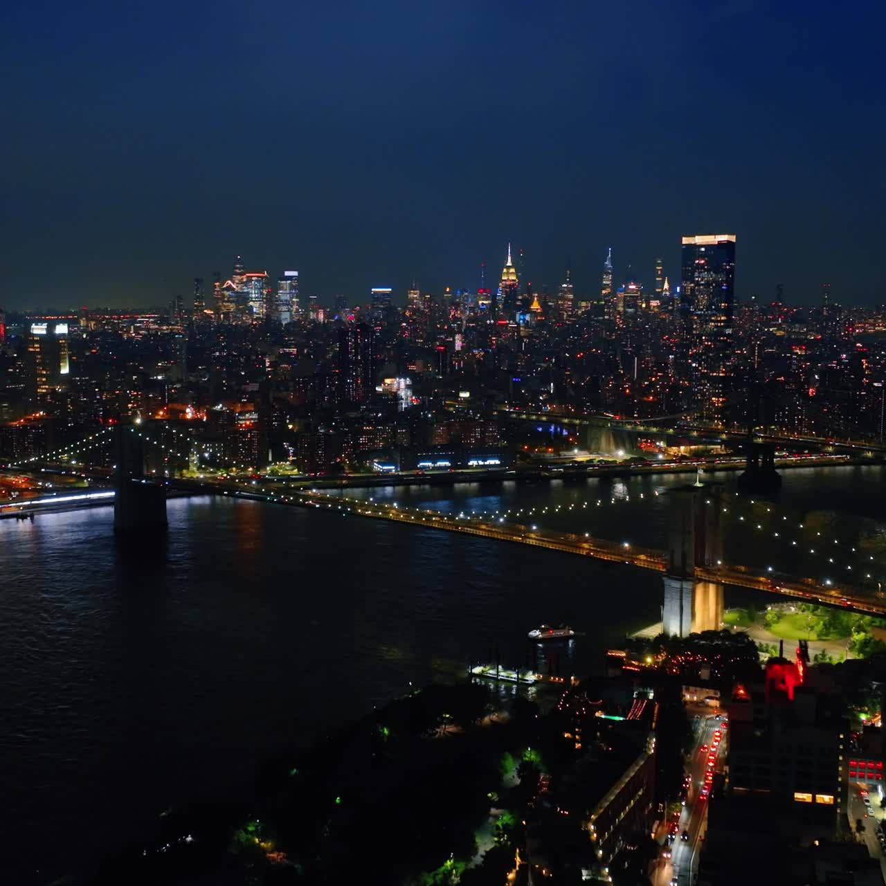 Lightening sparkles in the sky above beautiful New York. Night metropolis panorama from aerial view