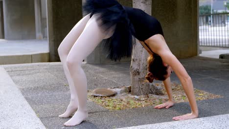 female ballet dancer stretching before dancing 4k