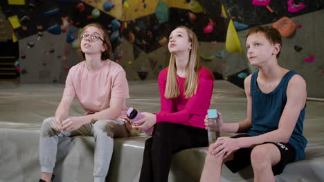 friends resting in a climbing gym