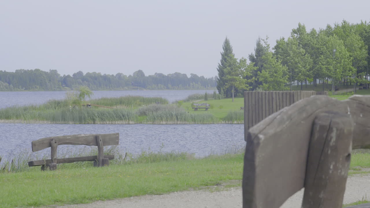 Empty benches by the lake on a cloudy day