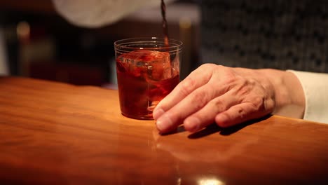 expert bartender stirring a drink at the bar