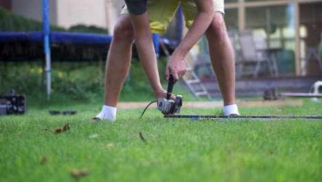 A-Skilled-Man-Sharpening-A-Steel-On-Bended-Knee---Wide-Shot