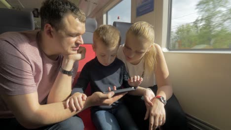 view of happy family in the railway trip using smartphone