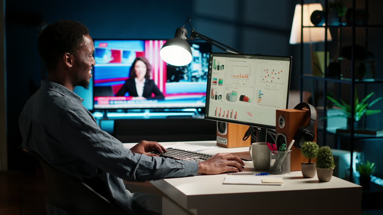 Network analyst studying digital commerce progression reports on computer