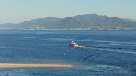 a fishing trawler sails calmly into the waters of north evoikos gulf for the daily catch, surrounded by serene seascape and soft morning light