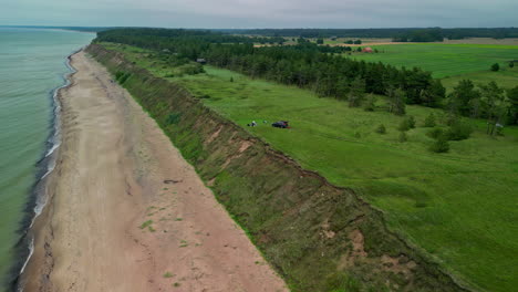 A-high-flight-along-the-coastline-with-small-holiday-homes-in-Jurkalne-on-the-Baltic-Sea-in-Latvia