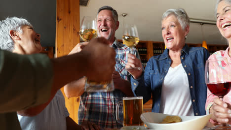 happy friends having drinks in bar 4k