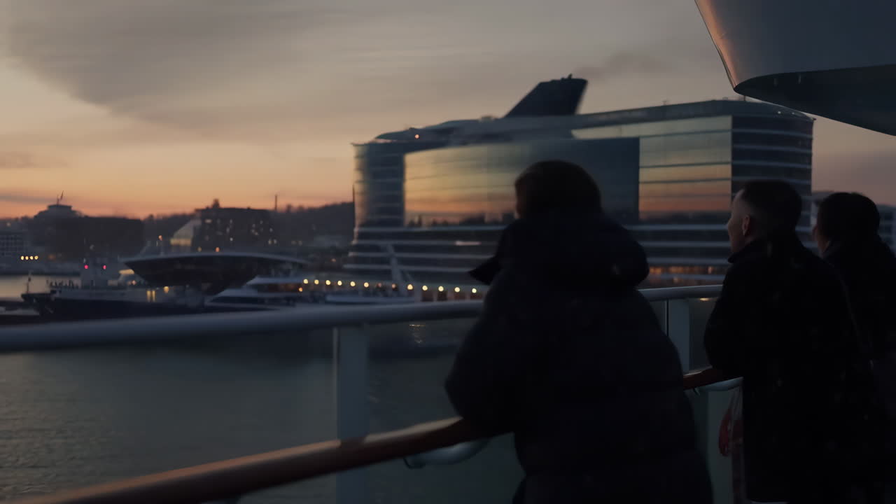 People overlooking a harbor at sunset