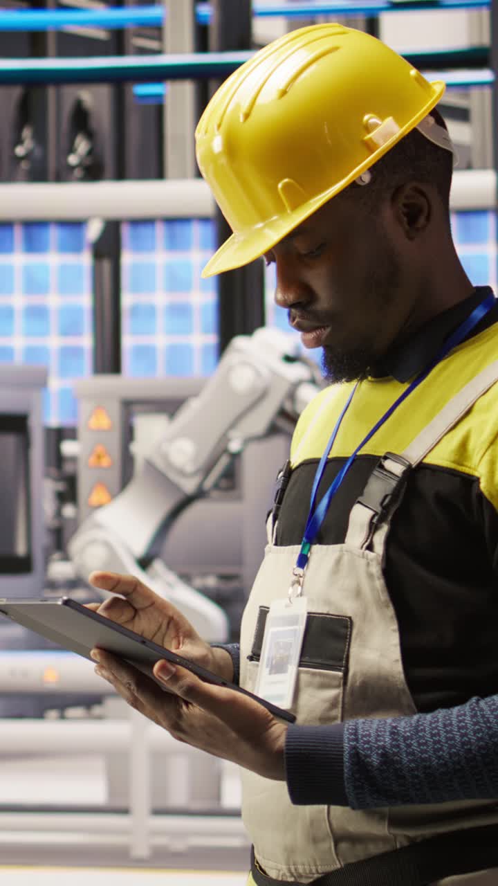 Vertical video Smart factory mechanic using tablet to analyze IoT sensors data