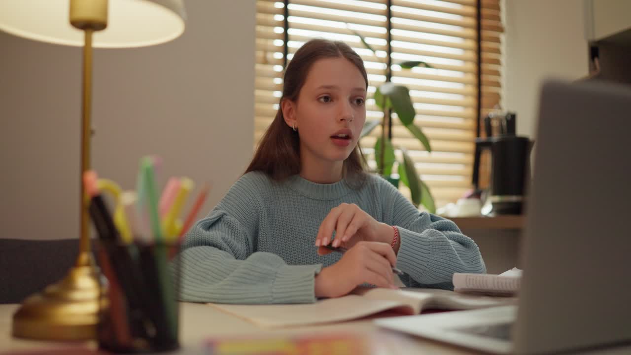 Teenage girl participating in online learning on her laptop at home