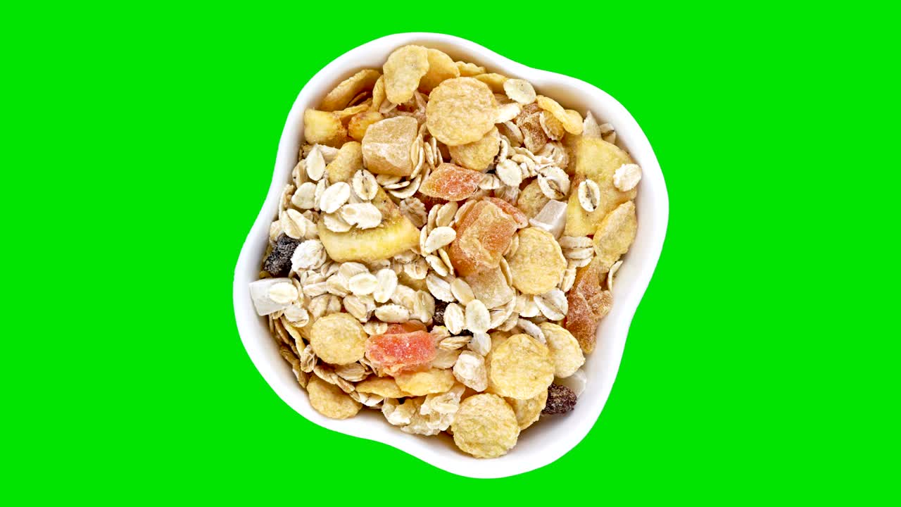Muesli in ciotola bianca in rotazione su schermo verde