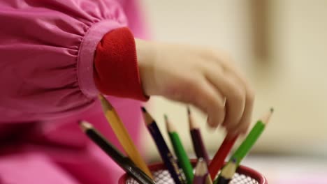 young childs hand coloring. close up of a young child hand coloring in the classroom