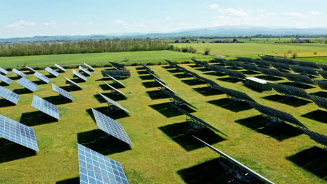 solar panels in a vast green field under a clear blue sky