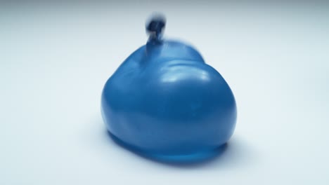 blue water balloon bouncing in super slow motion.  shot on phantom flex 4k.