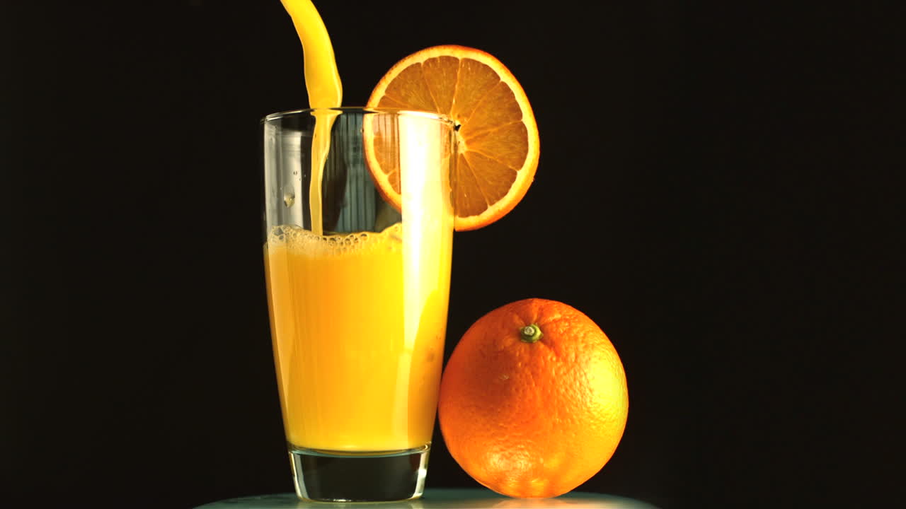 Glass of orange juice being poured