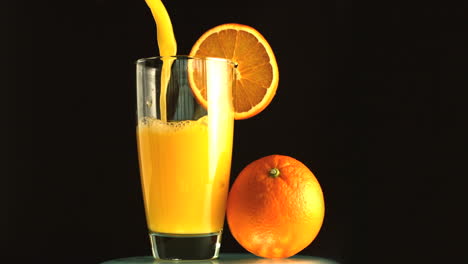 Glass-of-orange-juice-being-poured