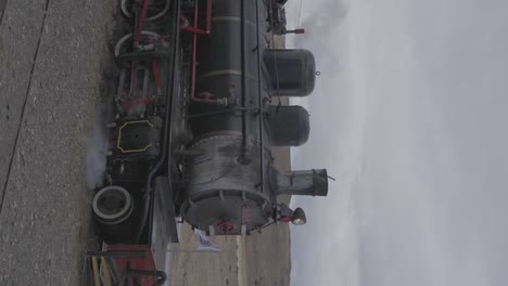 a vintage locomotive steam train traveling along the railroad train tracks in the mountains in patagonia, argentina