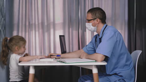 kid listens carefully to pediatrician