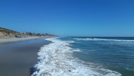 Drone flight over ocean waves on a beautiful sunny day in Carlsbad California