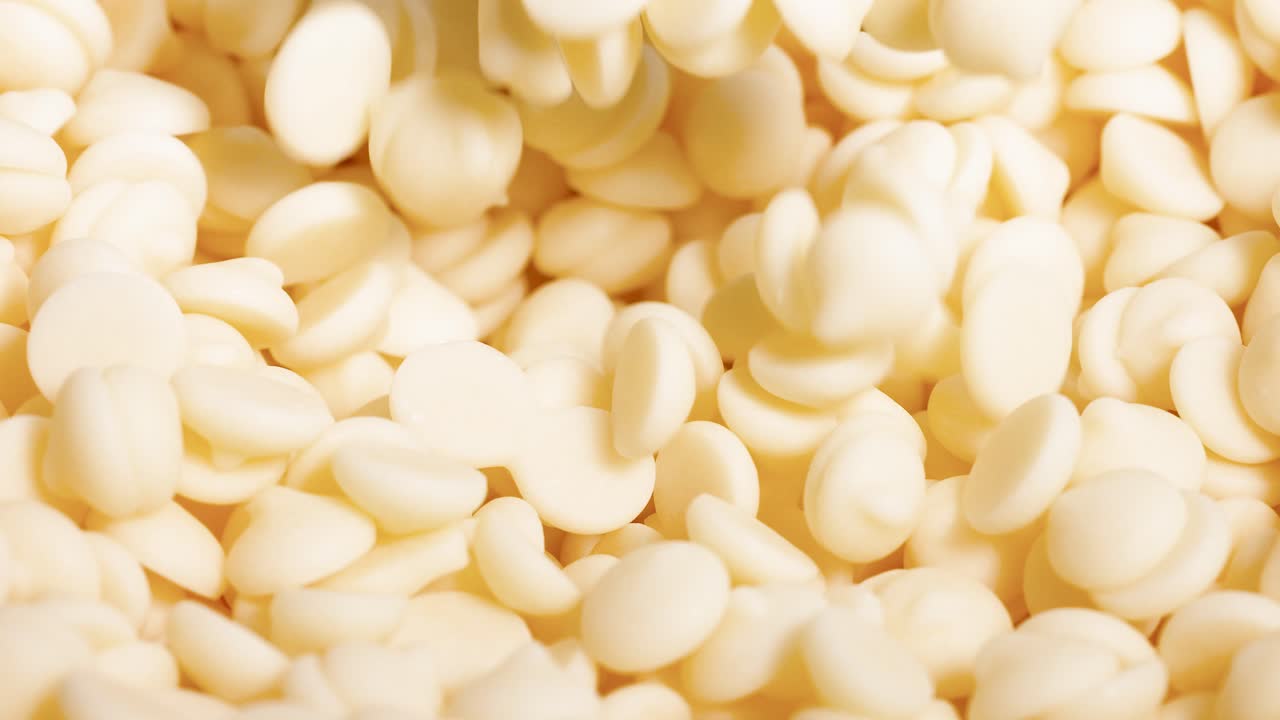 Spoon scooping white chocolate chips repeatedly