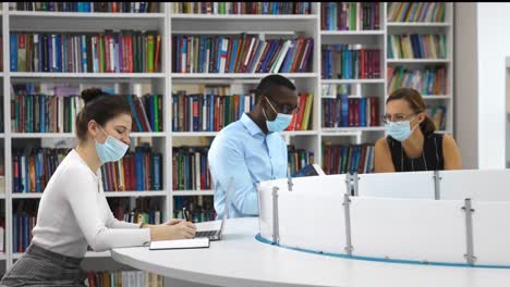 students studying in a library during the pandemic