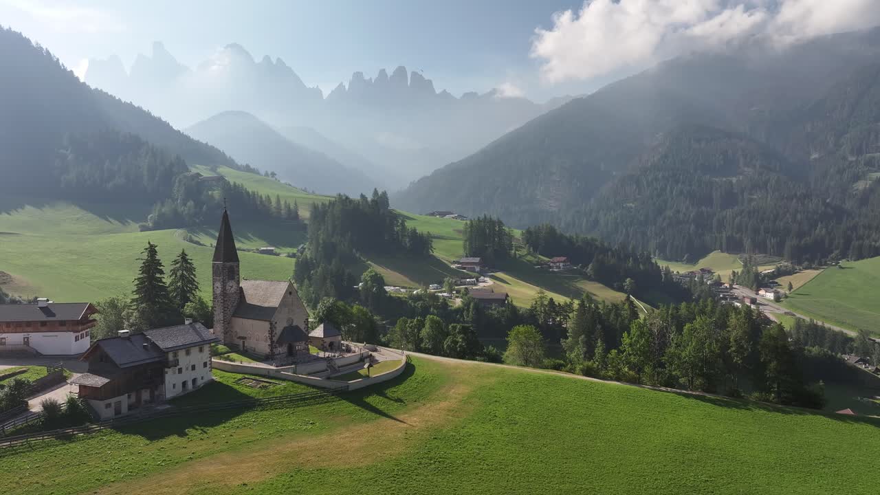 Aerial - Chiesa di Santa Maddalena with the Dolomites in the background, Italy