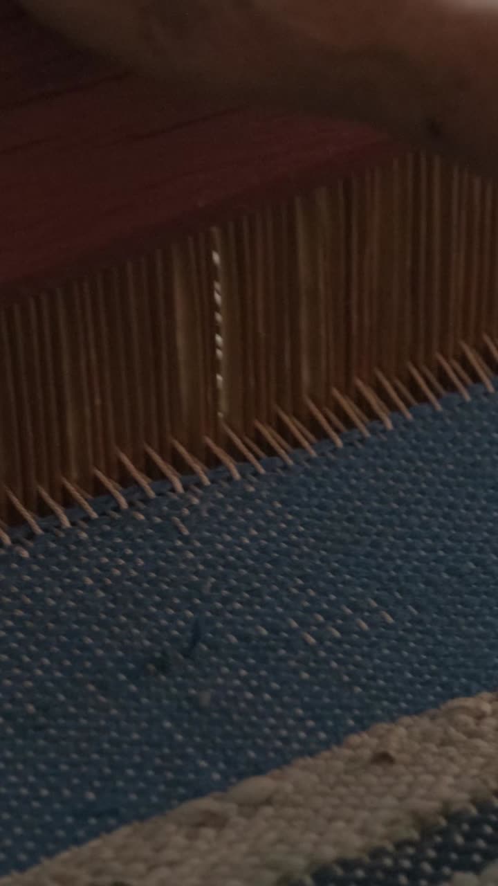 Close-up of Weaving Loom with Blue and White Textile