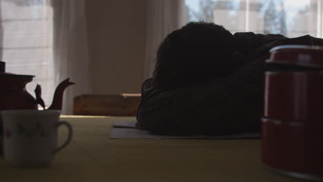 Man-in-despair-at-kitchen-table