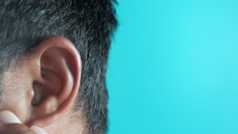 closeup of a person's ear and hand