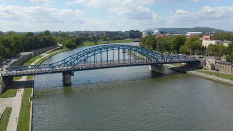 fixed aerial view of blue jozef pilsudski bridge in krakow, poland