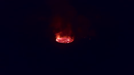 Night view of orange lava lake in crater of Mt Nyiragongo volcano
