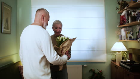 man bringing flowers to woman