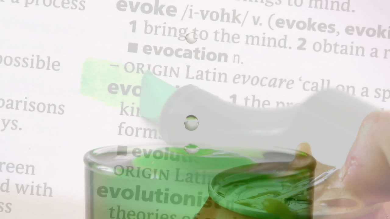 Animation of green liquid drop splashing over dictionary text in school setting