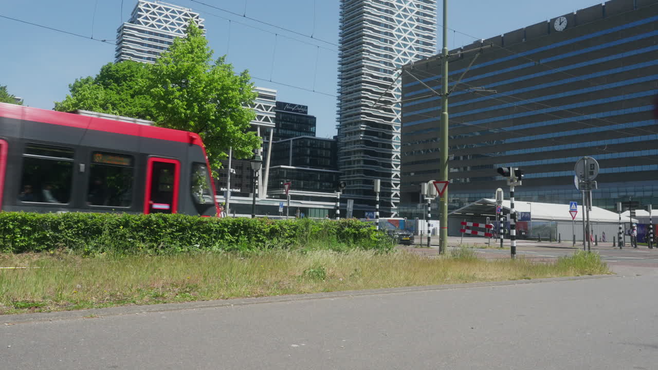 Public transport in the city of the Hague illustrated. In the proximity of the central station, the building with the clock in the background.