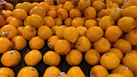 oranges neatly stacked in a supermarket display