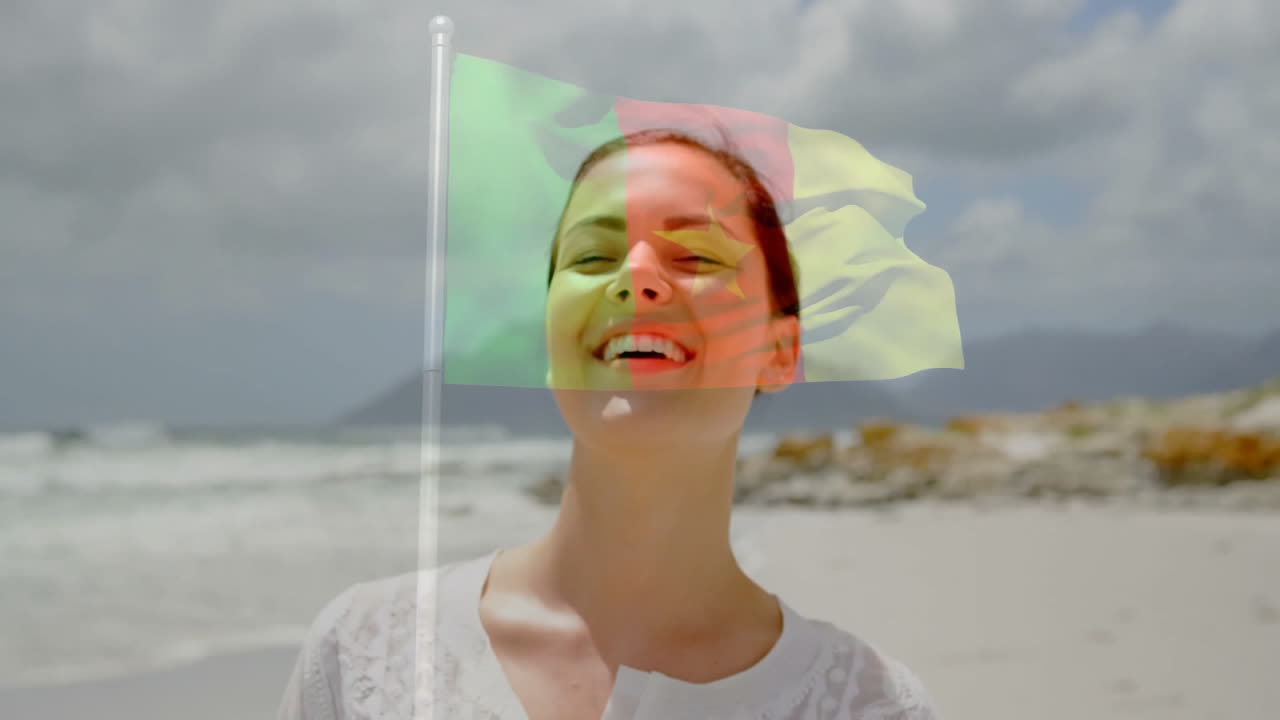 Holding flag animation overlay, person smiling on beach during sunny day