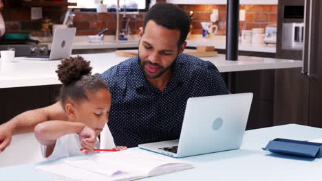 Father-Helps-Children-With-Homework-Whilst-Mother-Holds-Baby