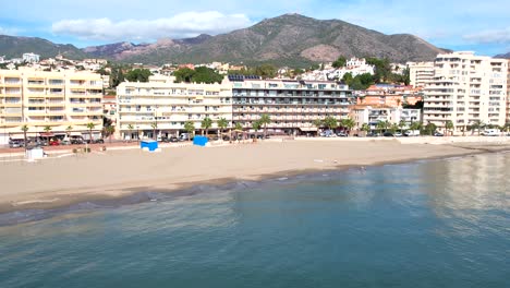 establishing sea aerial, tilting up to shore, resort boulevard in fuengirola