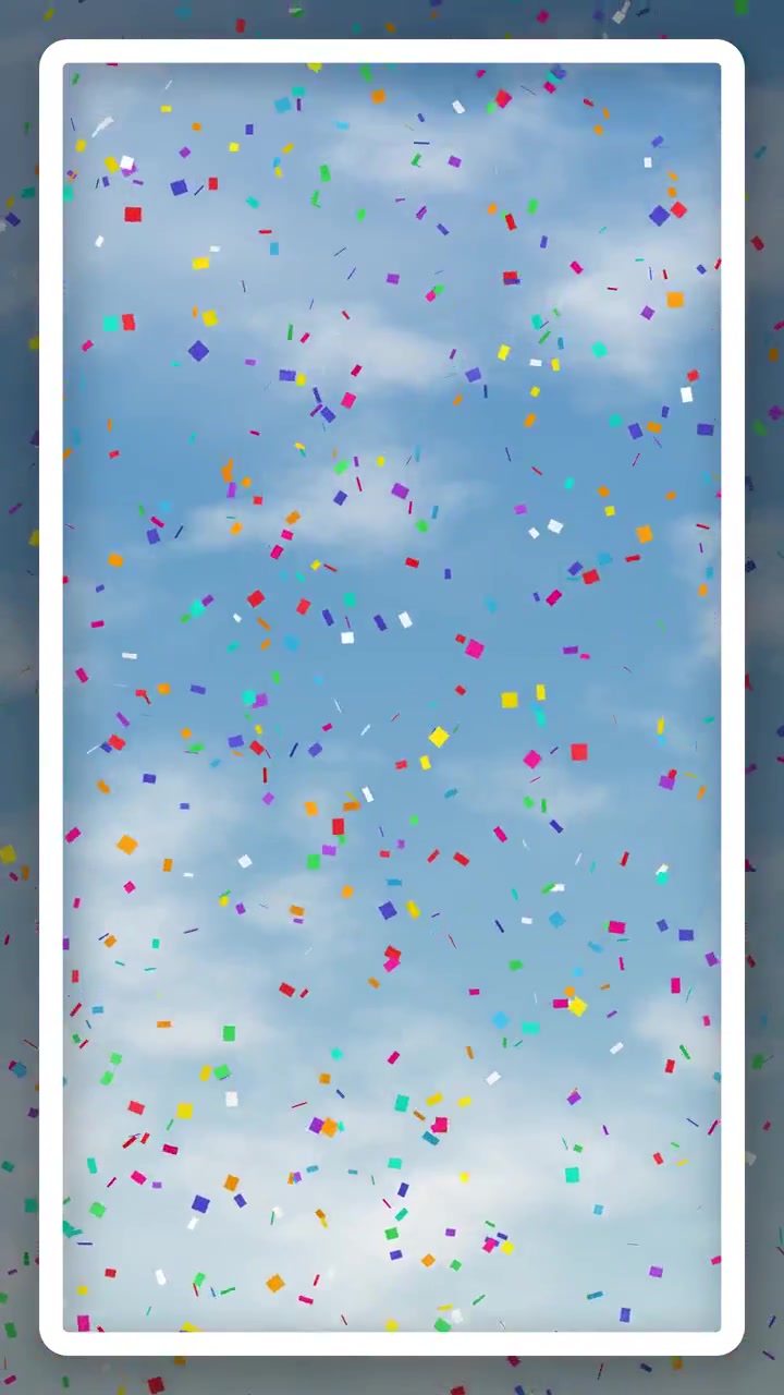 Confetti vivaci e multicolori fluttuano lentamente attraverso un cielo azzurro brillante con soffici nuvole bianche